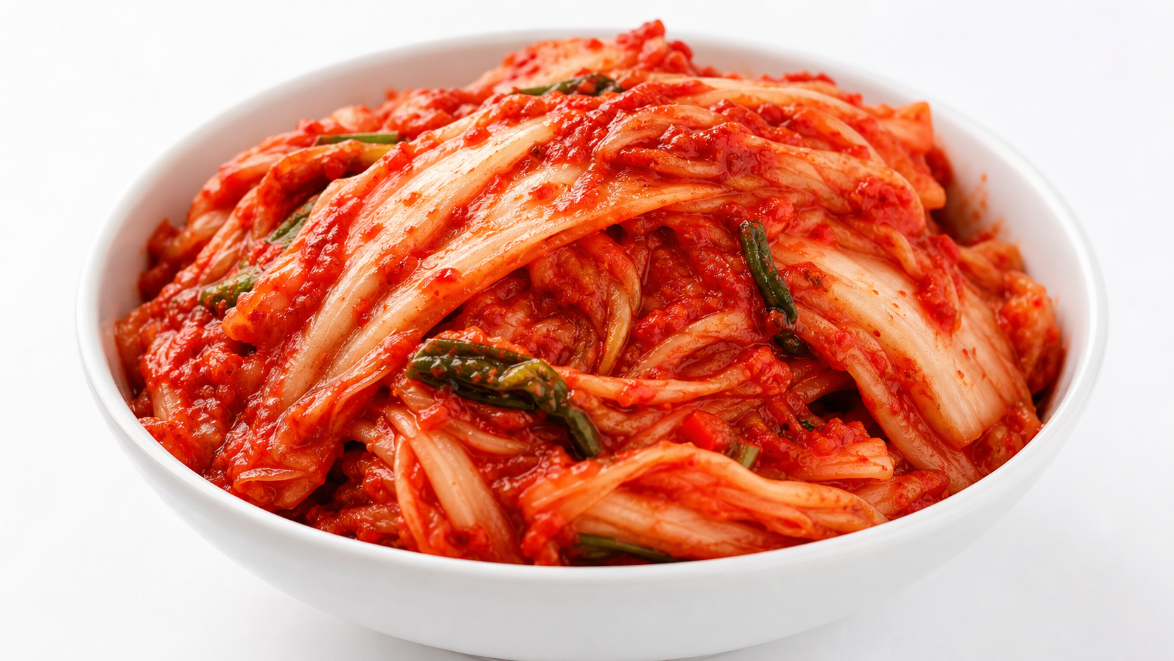 a bowl of vivid red kimchi close-up on a white surface, photorealistic 4K